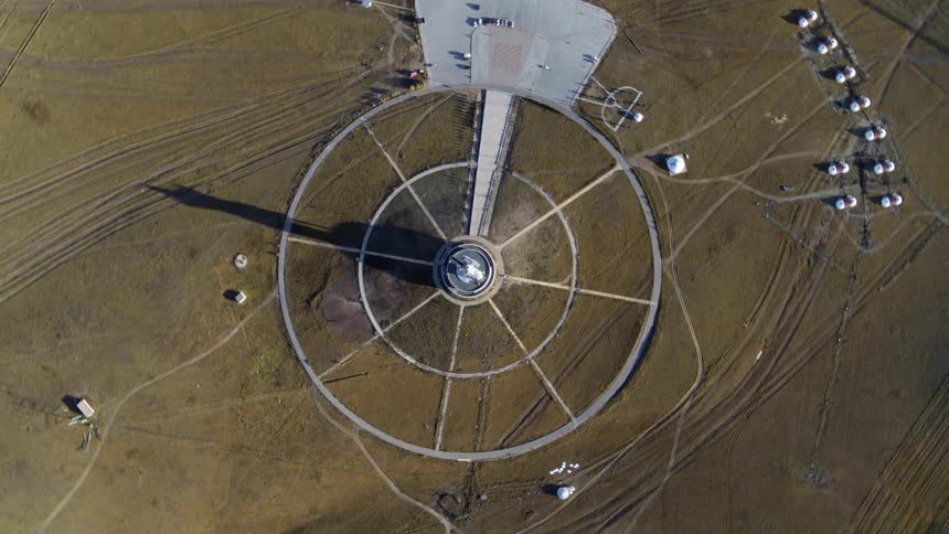 An aerial view of a round structure in a field