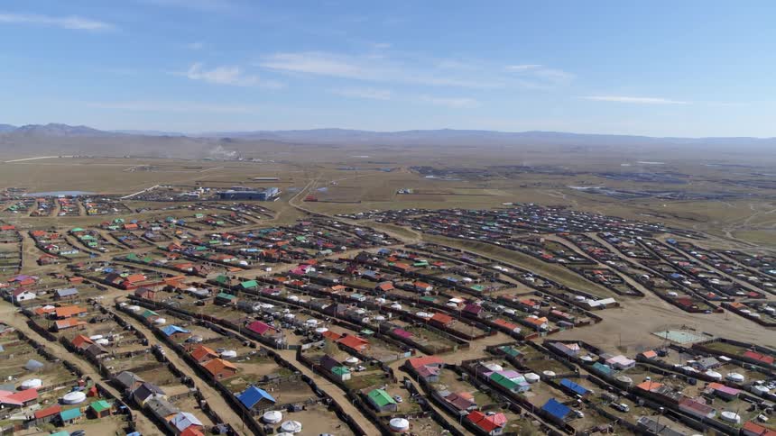 An aerial view of houses in a neighborhood in a rural area