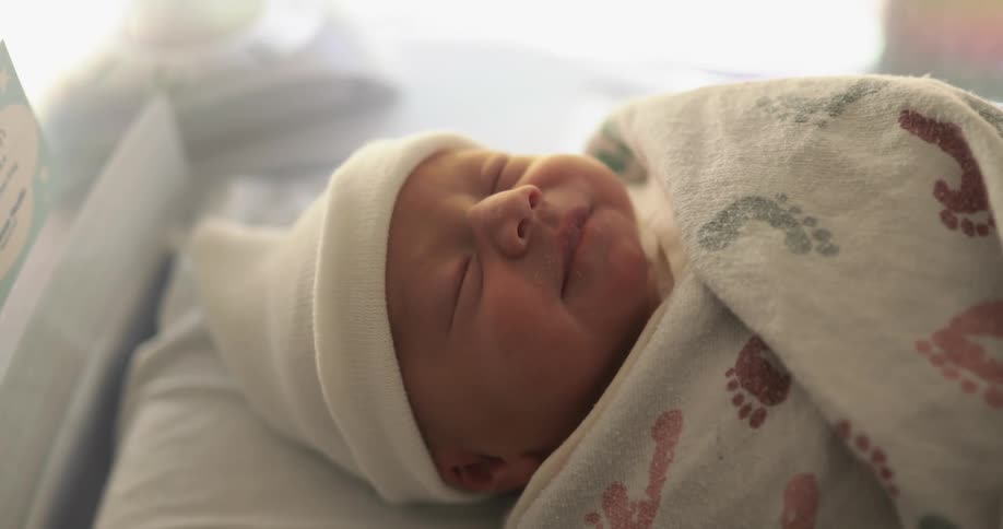 An infant is crying in its crib