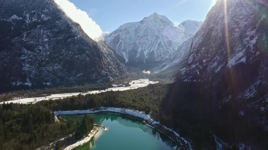 An aerial view of a river between some mountains