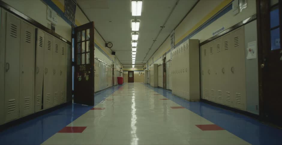 Rows of lockers on an empty highschool hallway