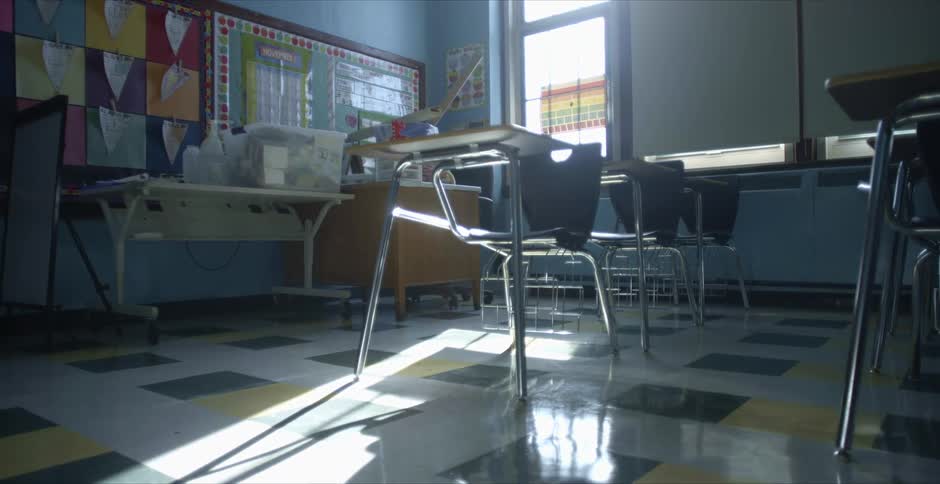 Sunlight reflecting over the chairs inside an empty classroom