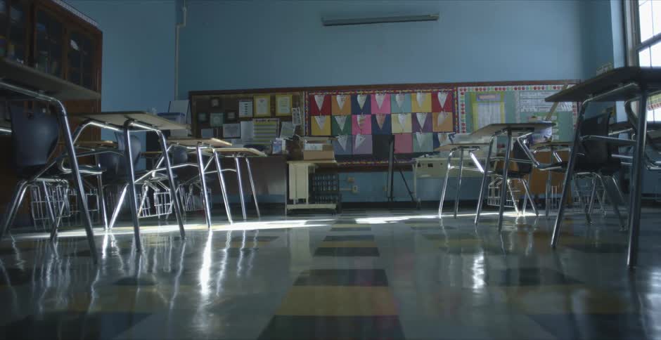 Rows of desks in an empty school classroom