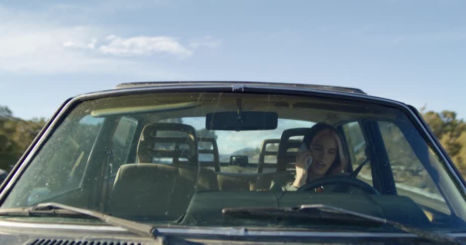 A woman driving down a road