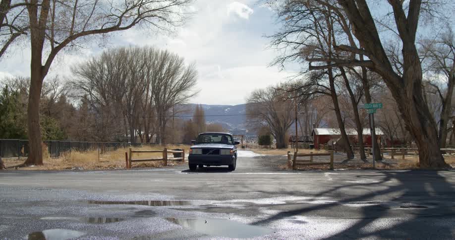 A woman driving a car and making a right turn