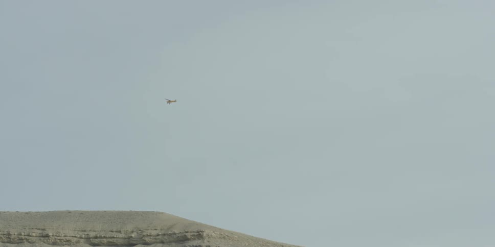 A single engine plane in the air in the daytime