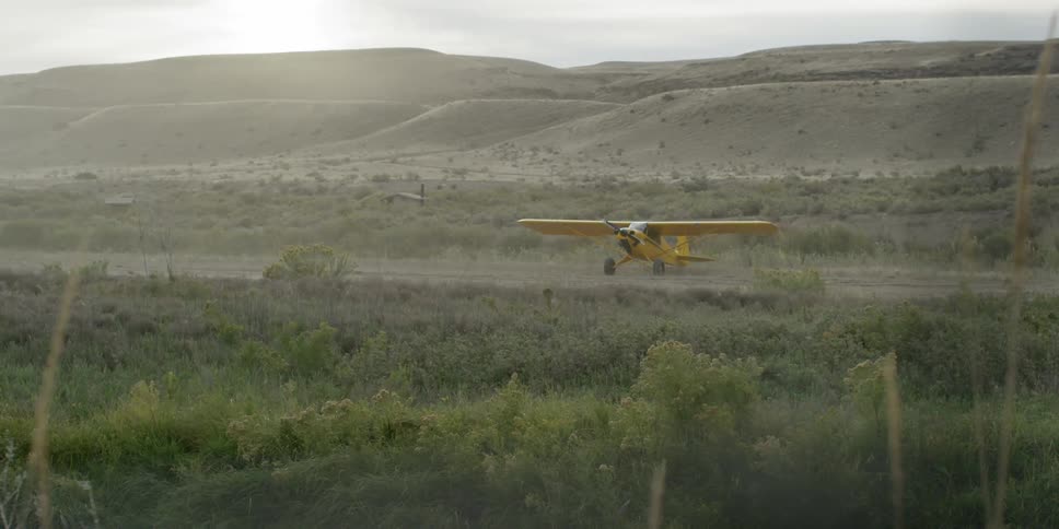 A plane sits still on a small runway