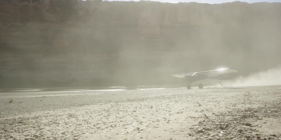 A plane moves down a dirt trail