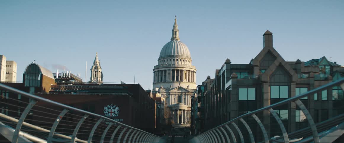 A bridge leading to a government building on a sunny day