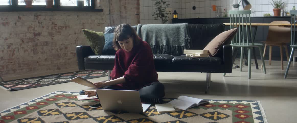A woman reading something on a laptop