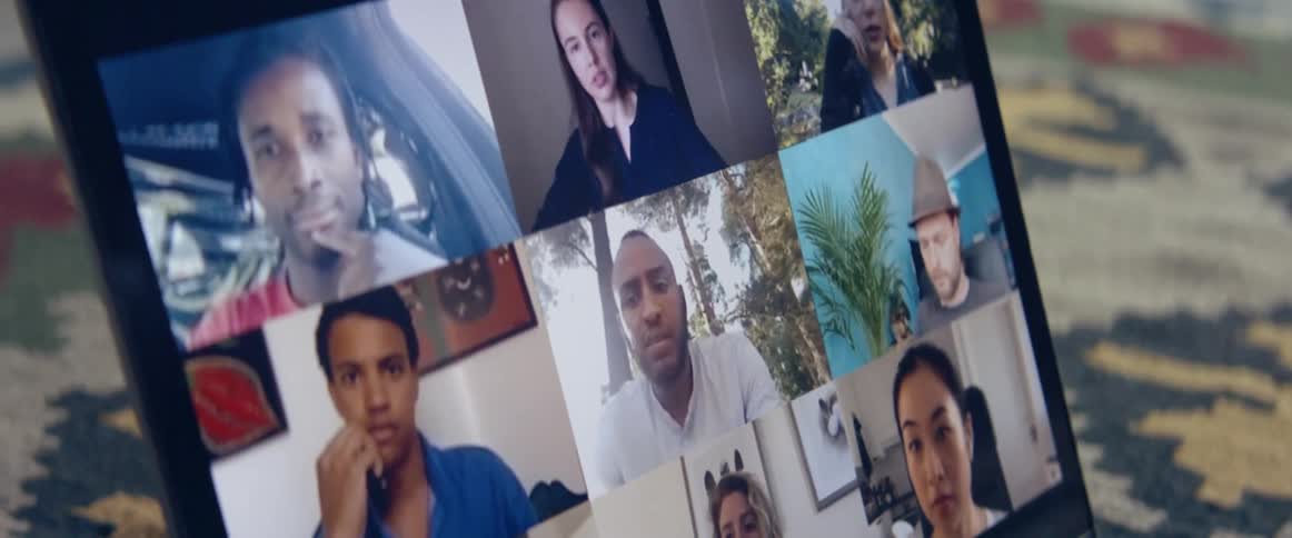 A laptop inside a home with people on the screen as they video chat