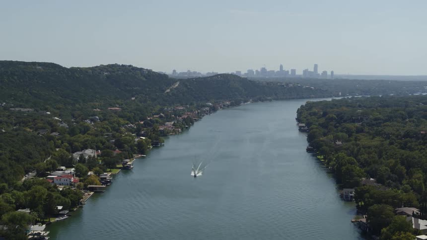 A boat travels quietly along a neighborhood river