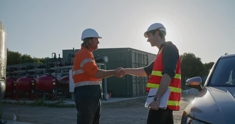 Two construction workers shaking hands