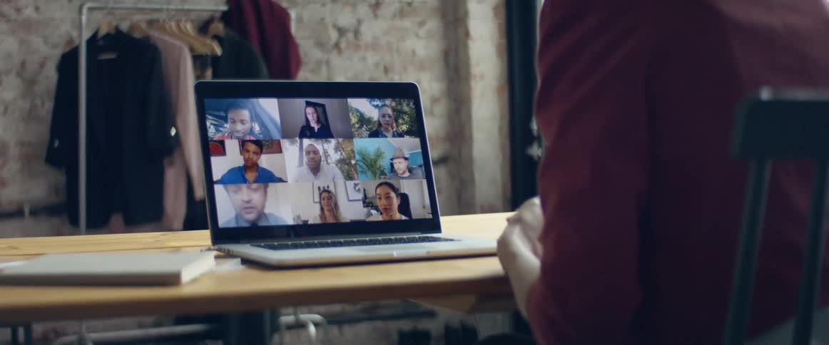 A group of people talking on a laptop