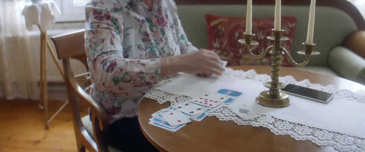 A woman playing cards by herself