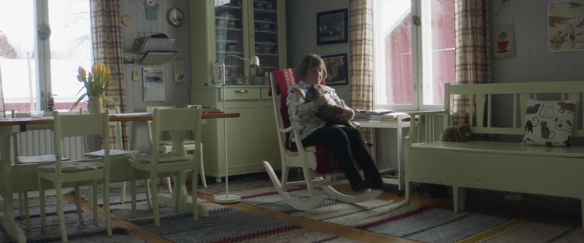 A woman sitting down with her cat