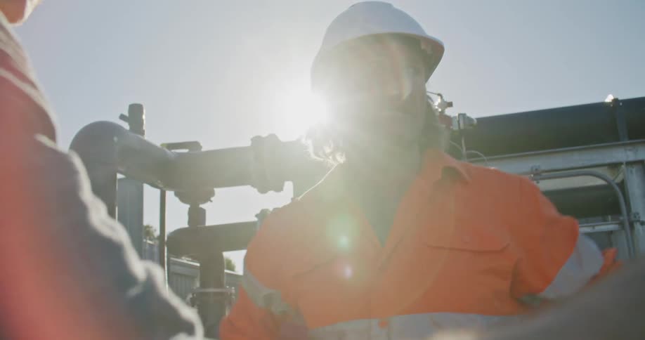 Two coworkers talking on a construction site