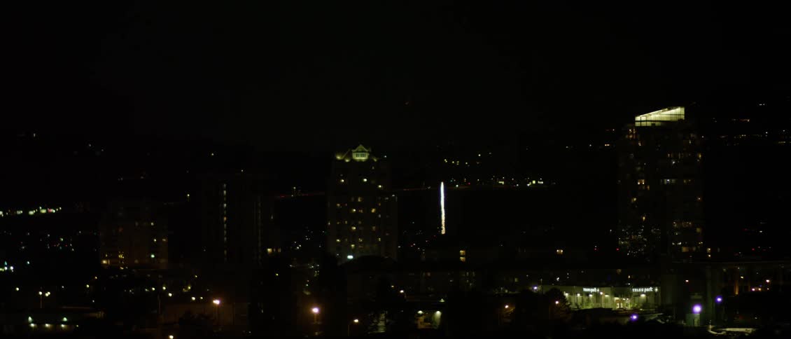 Fireworks exploding over the city skyline at night