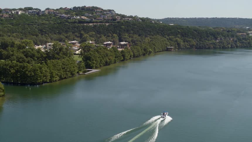 A view of a boat that is traveling down a river