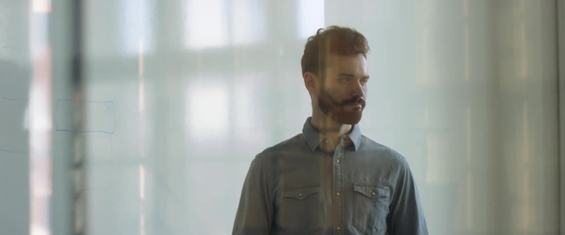 Man writting on a whiteboard in an office meeting in the conference room