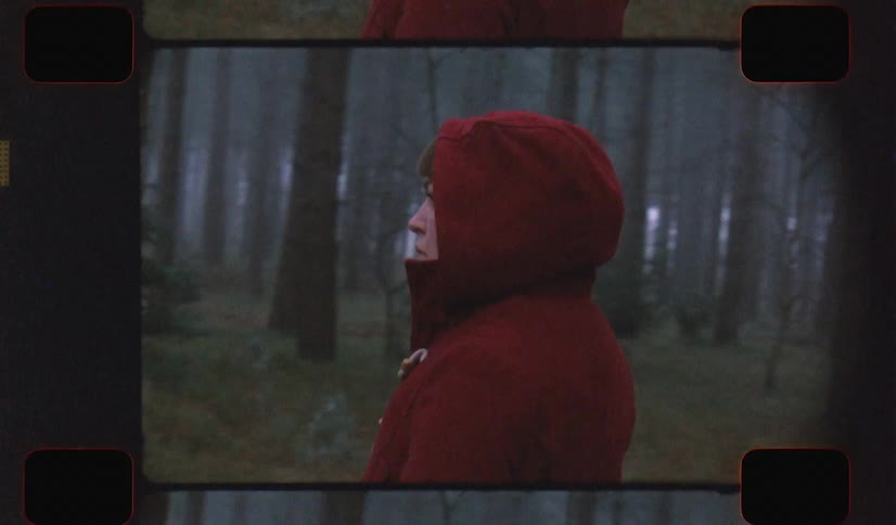 A filmstrip of a woman walking through the forest and looking around