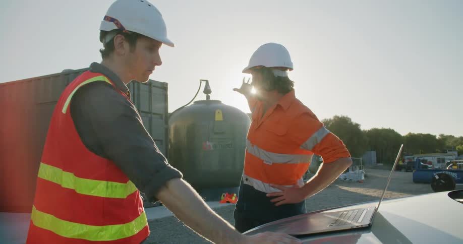 Two coworkers going over plans for construction
