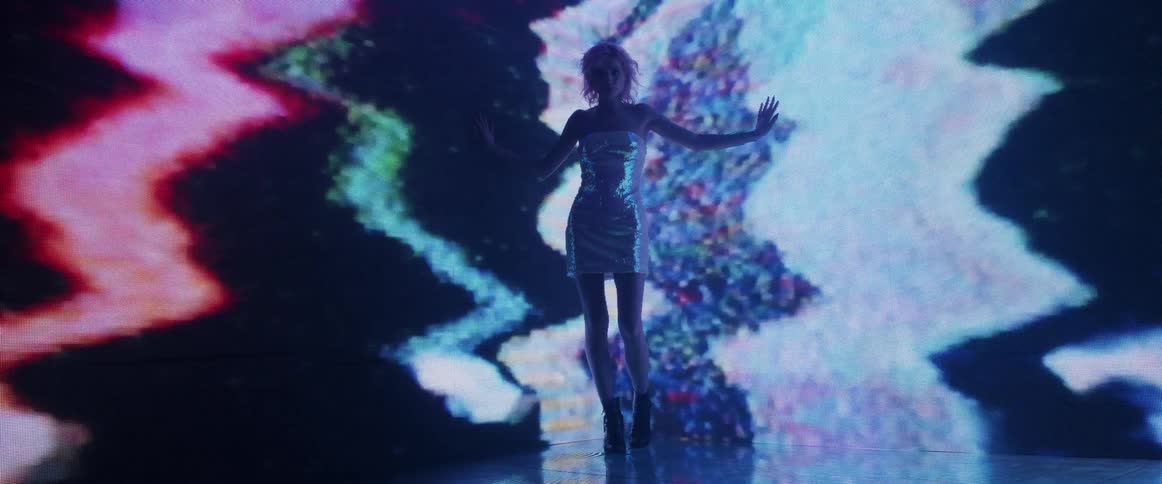 A model poses in front of flashing lights