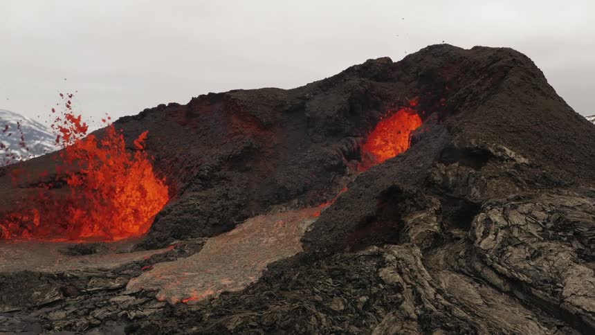 Lava flowing as a volcano erupts
