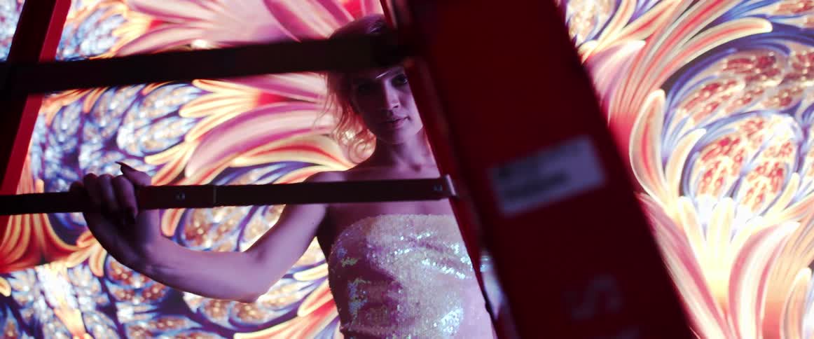 A portrait of a woman in a room with a mural