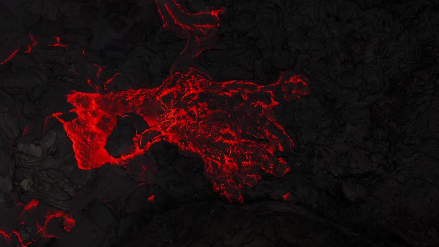 Glowing red hot lava flows breaking up rock