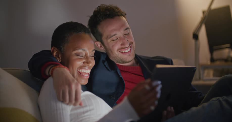 Two people that are dating are sitting on the couch together