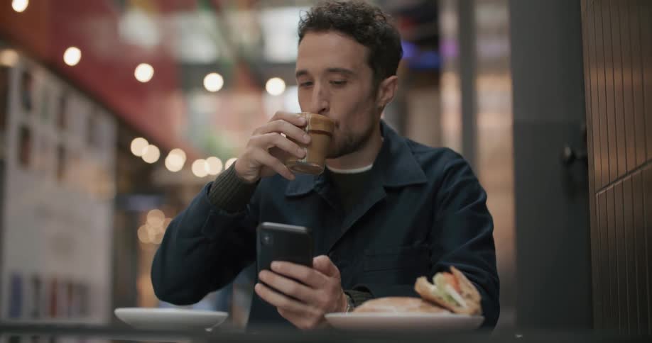 A man relaxing sitting around on his smartphone