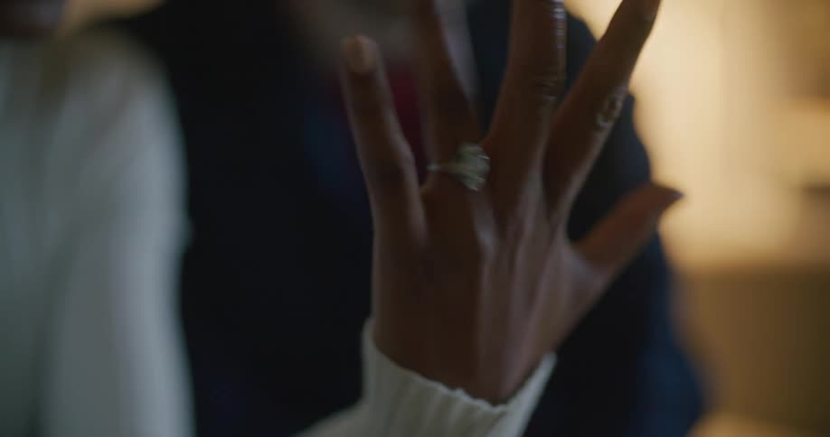 A woman is showing off her engagement ring