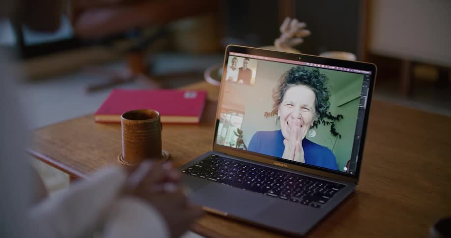 A person is video chatting with someone on a laptop