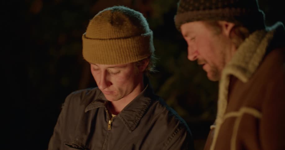 Father and son preparing a fish to cook