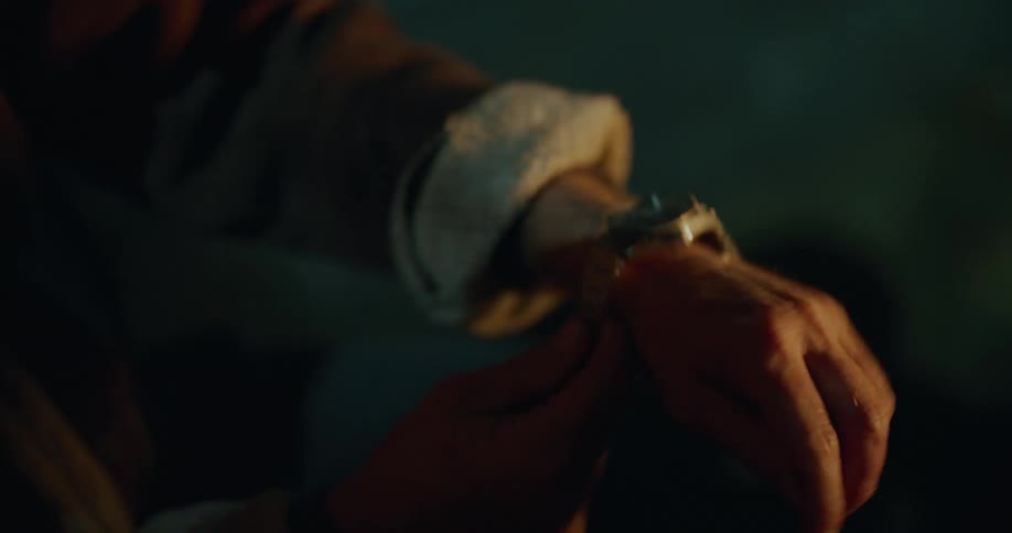 A man showing off a watch while camping