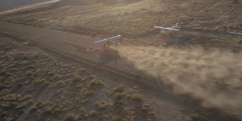 A plane is moving fast down a runway