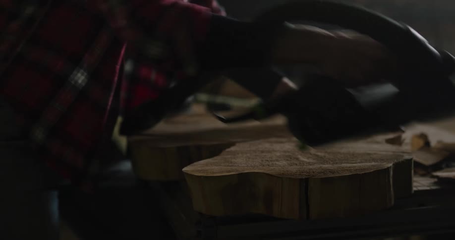 A woman puts on safety goggles before using a sander on a wood slab