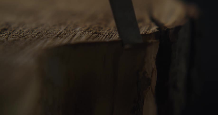 A close up of a wood being chiseled