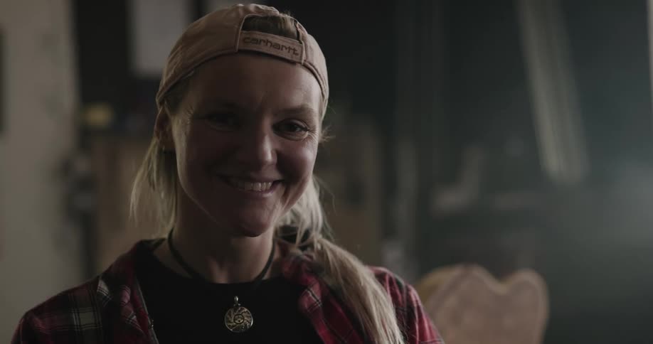 A woman at home smiles and laughs