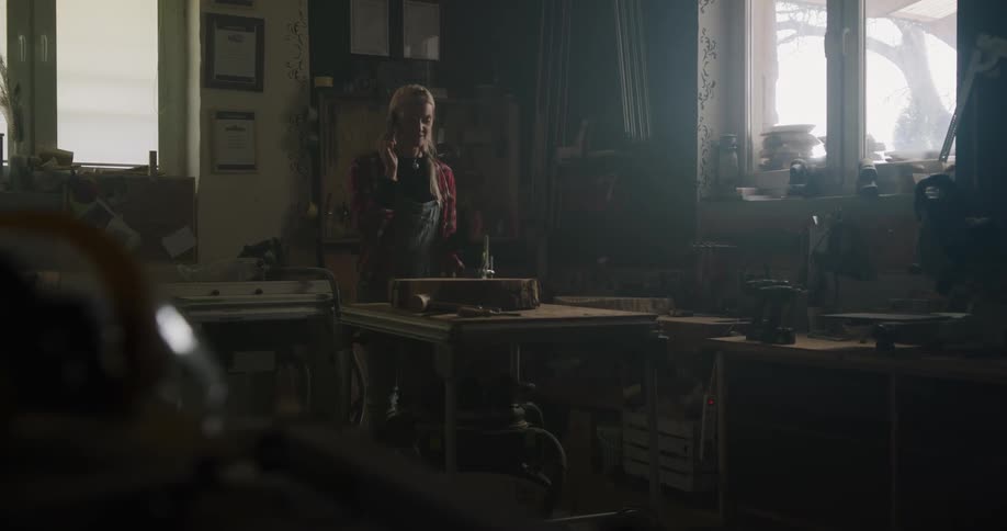 A woman talking on a phone walking around a room