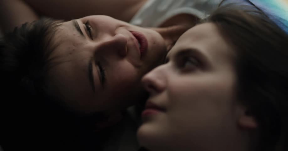 Two women are laying down together