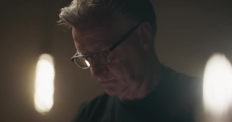 A man standing in a room looking at something