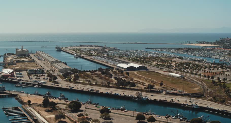 A marina with docs with the ocean sky and clouds in the background