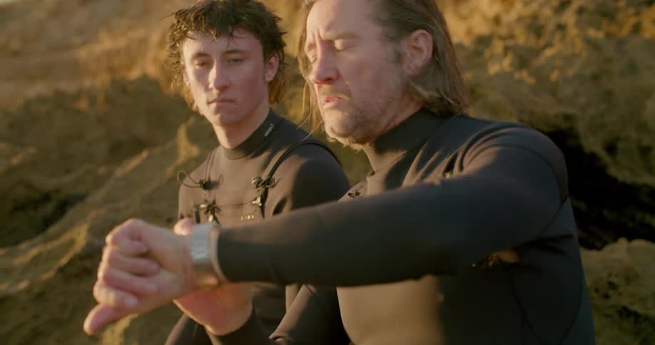 Two men are talking outdoors together