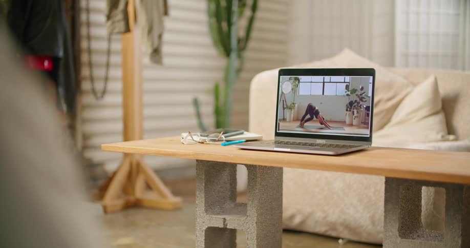 A man does an online yoga class