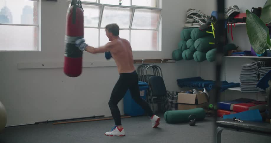 A man punches a bag as he exercises