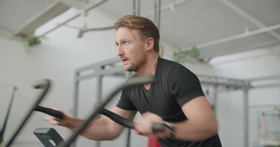 A man breathes heavilu as he exercises