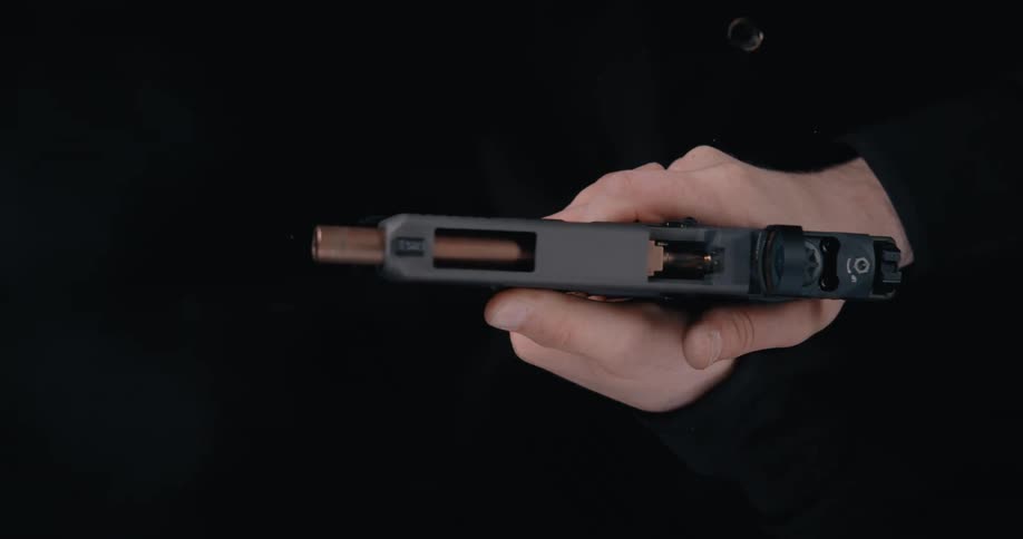 A person fires a hand gun