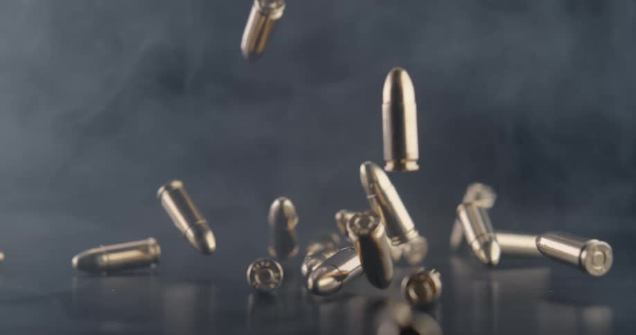 Bullets fall on the counter in the smoke filled room